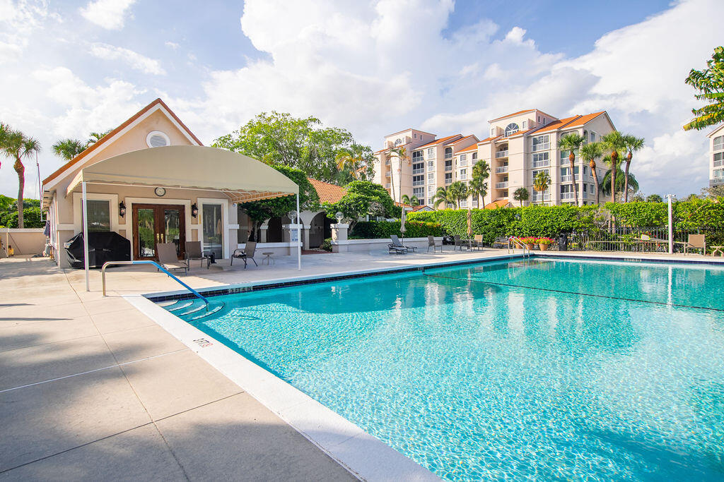 17031 Boca Club Boulevard, Unit 65A Boca Raton, FL 33487 - Photo 26 of 34 a view of a house with a yard table and chairs