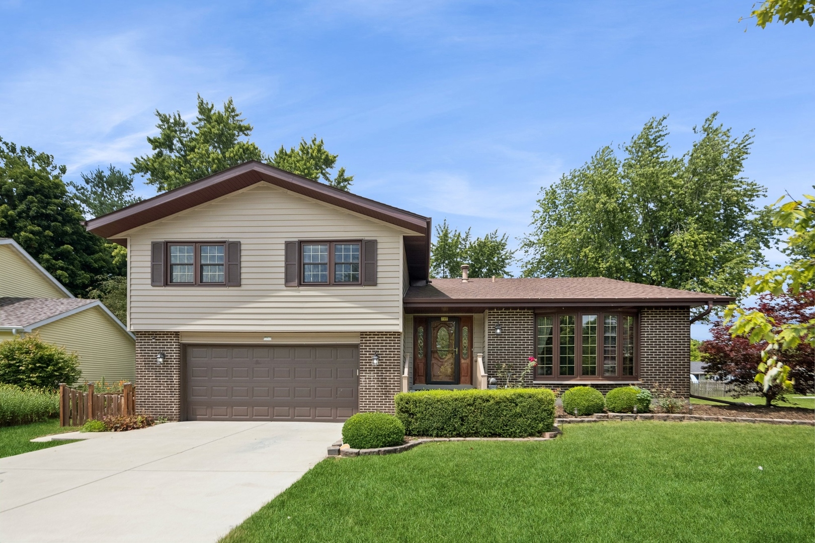 15216 South Clover Court Plainfield, IL 60544 - Photo 1 of 35 a front view of a house with a yard and potted plants
