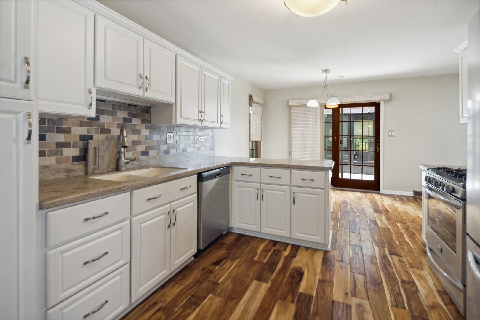 15216 South Clover Court Plainfield, IL 60544 - Photo 11 of 35 a kitchen with granite countertop white cabinets and white appliances