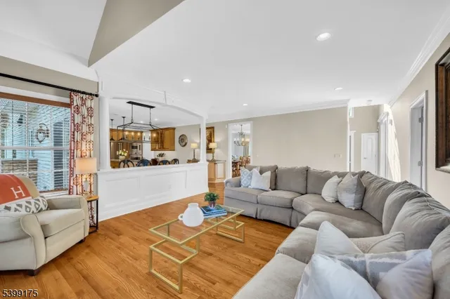 a living room with furniture and view of kitchen