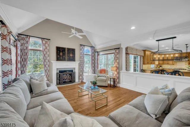 a living room with furniture large window and a fireplace
