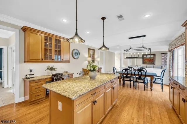 a kitchen with a table chairs and wooden floor