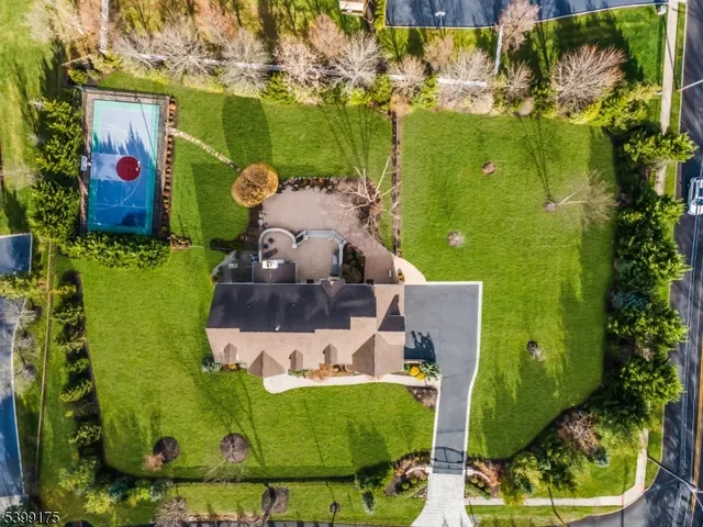 an aerial view of a house with outdoor space tennis court