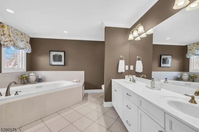 a bathroom with a bathtub a sink and a mirror