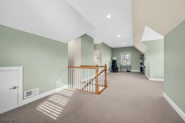 a living room with furniture and a book shelf