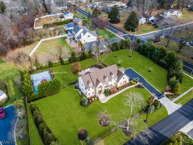 an aerial view of a house with a garden and swimming pool
