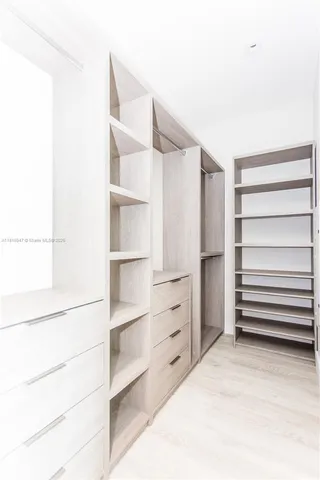 a bathroom with a shower and a glass door