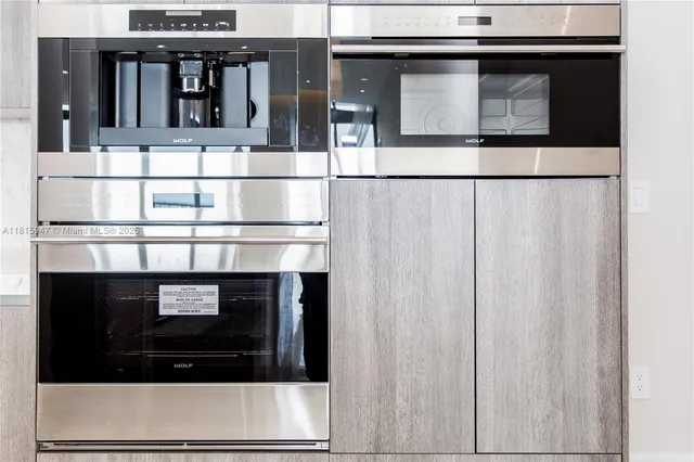 a stove top oven sitting inside of a kitchen