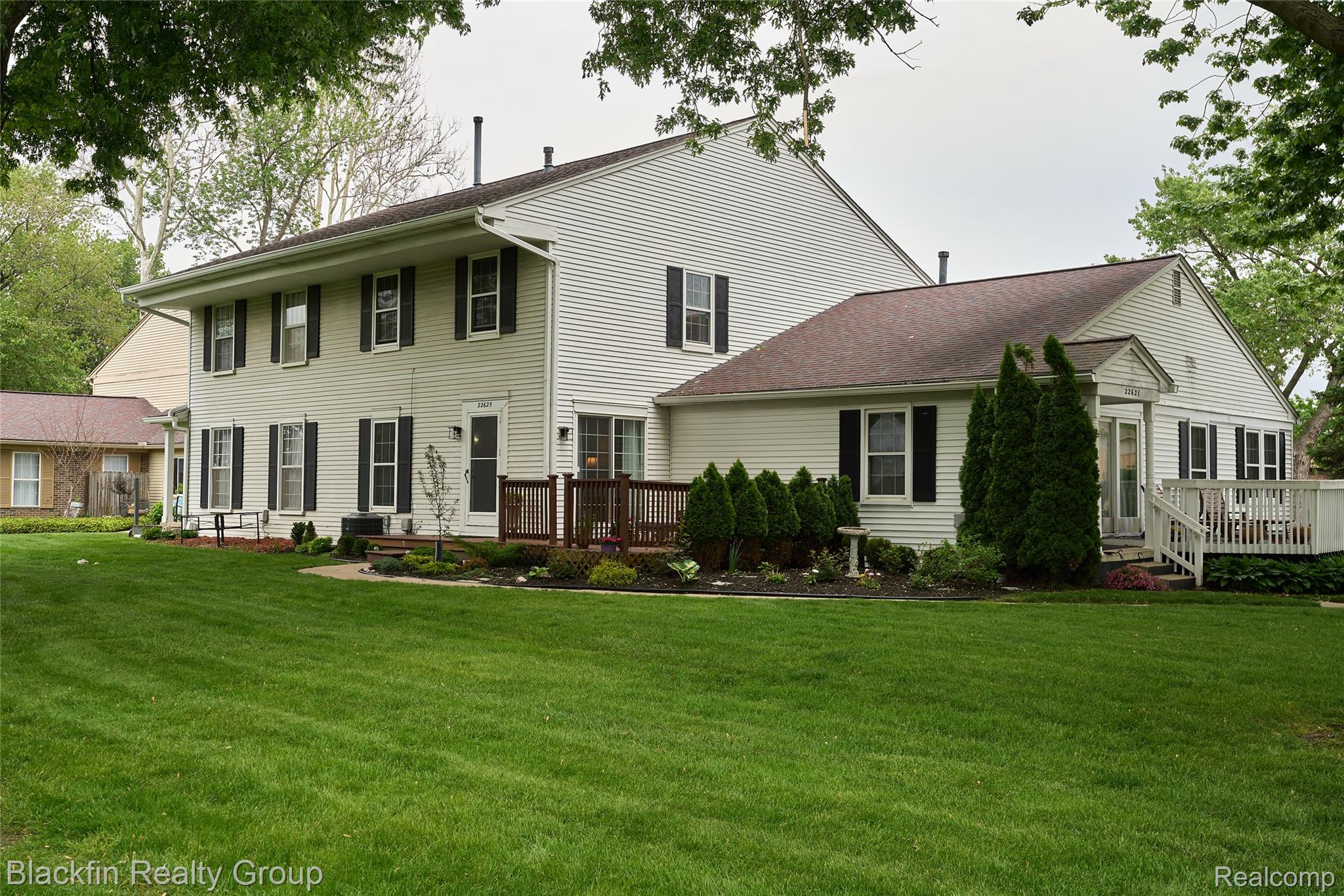 22625 Martin Road St. Clair Shores, MI 48081 - Photo 4 of 23 Rear view of property with a lawn and a wooden deck