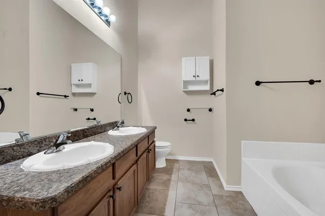 a view of a big room with a ceiling fan and a window