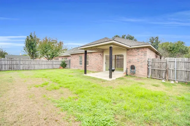 a front view of a house with a garden and yard