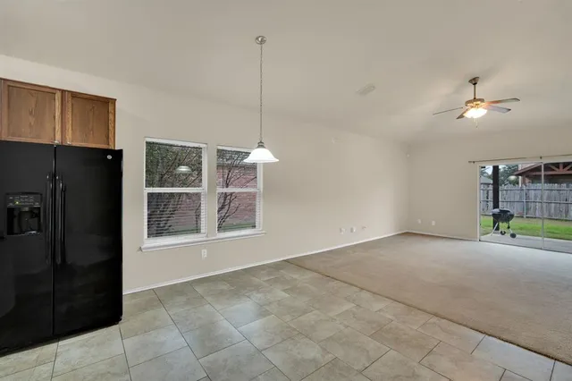 a kitchen with granite countertop stainless steel appliances a sink stove and refrigerator