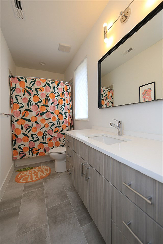 211 South Pettigrew Street Raleigh, NC 27610 - Photo 25 of 29 Bathroom with custom bath fixtures and countertop, tub, shower and tile floors. Bathroom