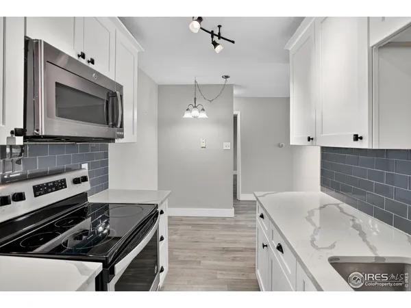 a kitchen with a stove and a microwave