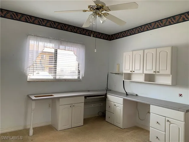 a kitchen with sink cabinets and window