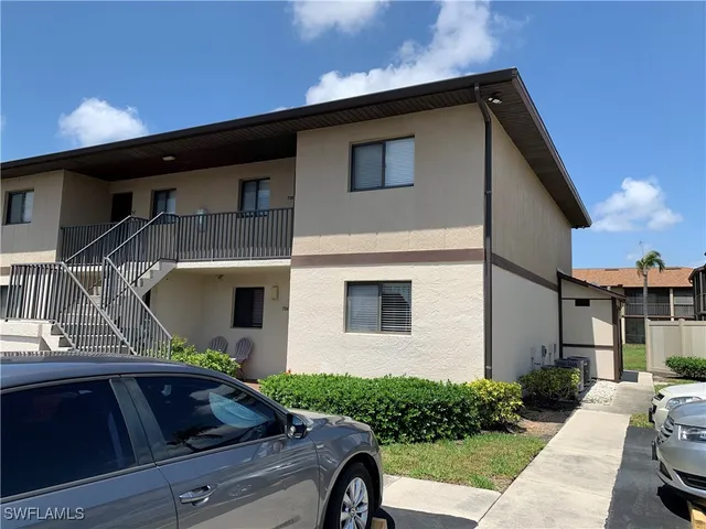 a car parked in front of white house