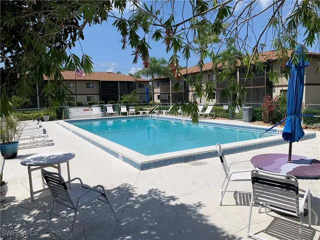 a view of a house with swimming pool and sitting area
