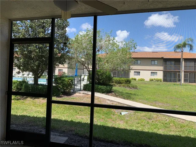 a view of a house with a yard from a balcony