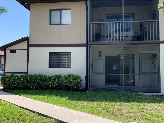 a view of a house with a small yard and plants