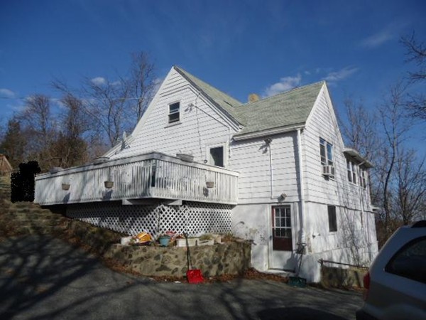 a view of a house with a wooden fence