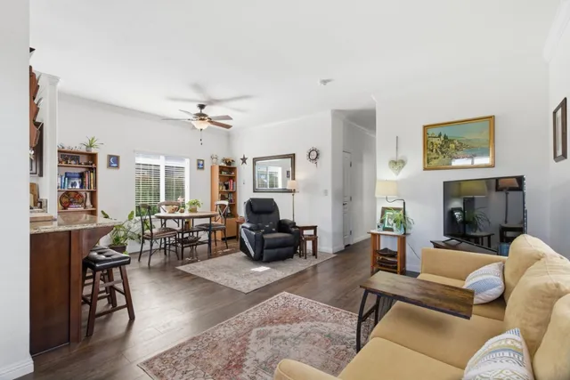 a bedroom with a bed and a lamp on dresser