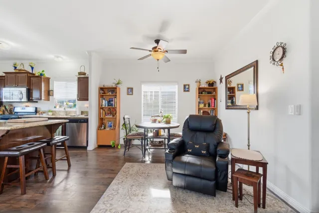 a view of a patio with table and chairs potted plants and large tree