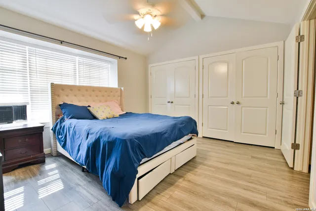 a spacious bedroom with a bed and a window