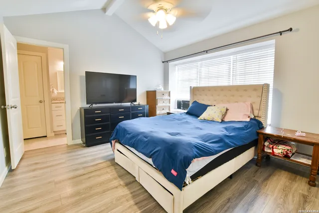 a bed room with a bed and a television