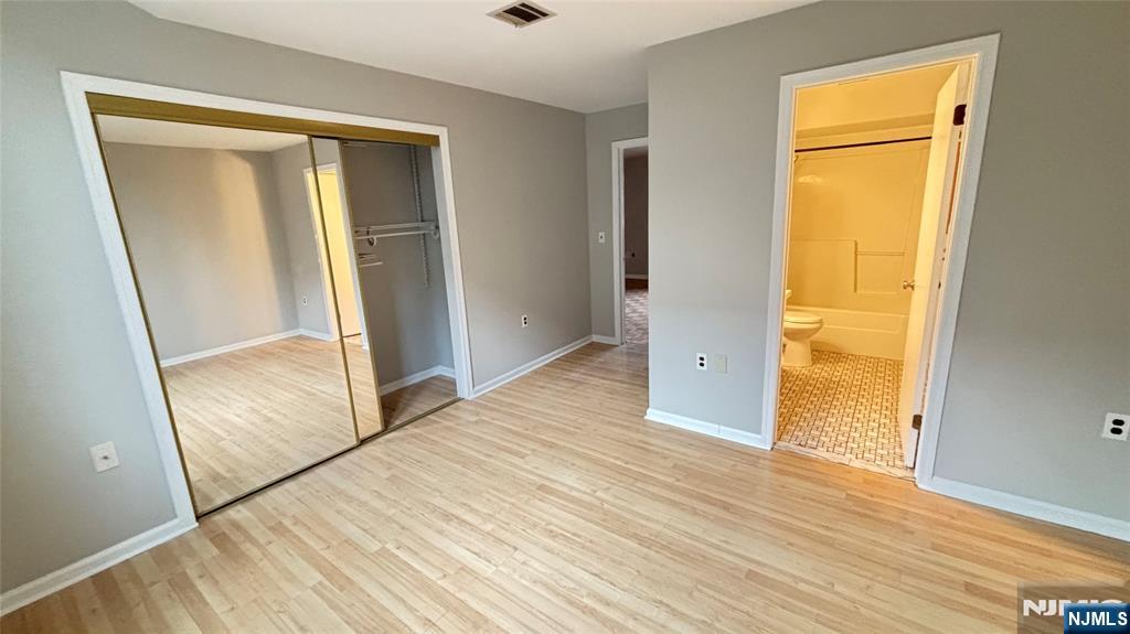 308-310 Passaic Avenue, Unit 201 Harrison, NJ 07029 - Photo 8 of 31 a view of an empty room with wooden floor and a window
