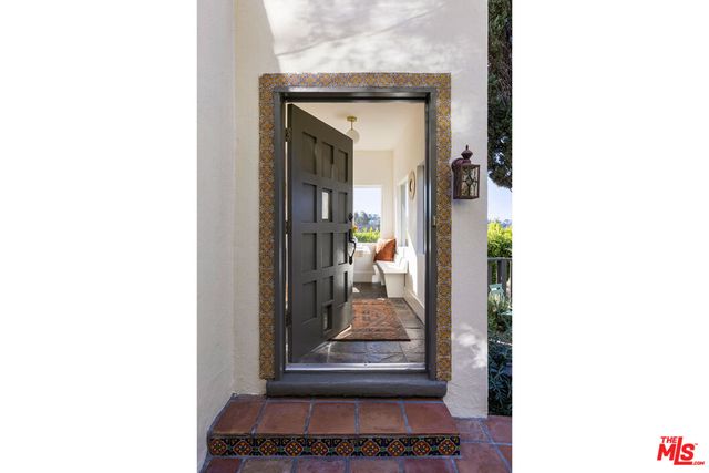 a living room with a bed and a mirror