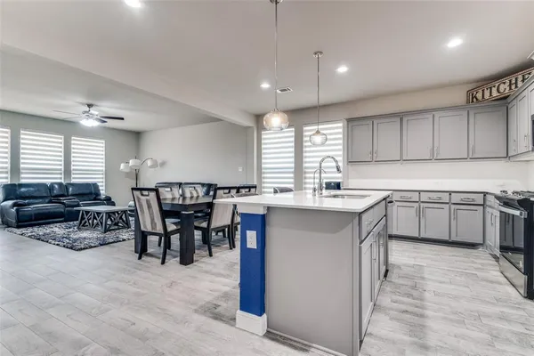a kitchen with stainless steel appliances granite countertop a sink counter space and a window