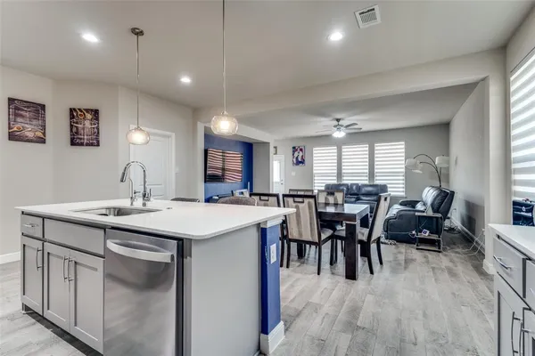 a view of a dining room with furniture and chandelier