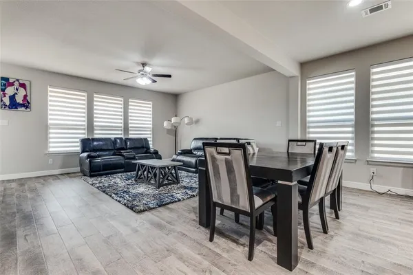a living room with furniture a wooden floor and a window