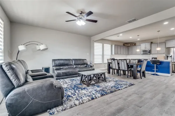a living room with furniture and kitchen view