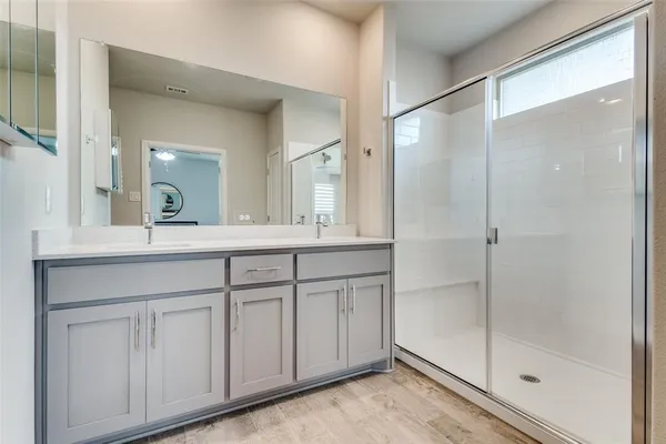 a bathroom with a shower sink and mirror