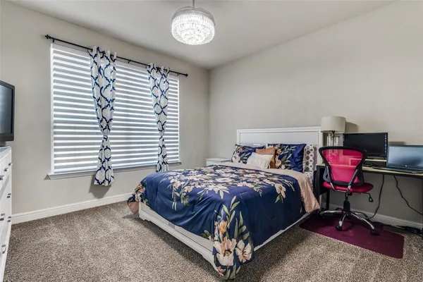 a bedroom with a bed chair and window