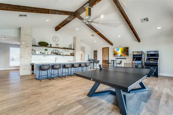 a living room with stainless steel furniture kitchen view and a table
