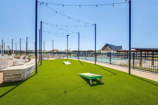 a swimming pool with outdoor seating and yard