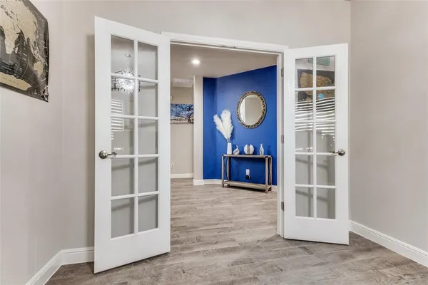 a view of a room with wooden floor and window
