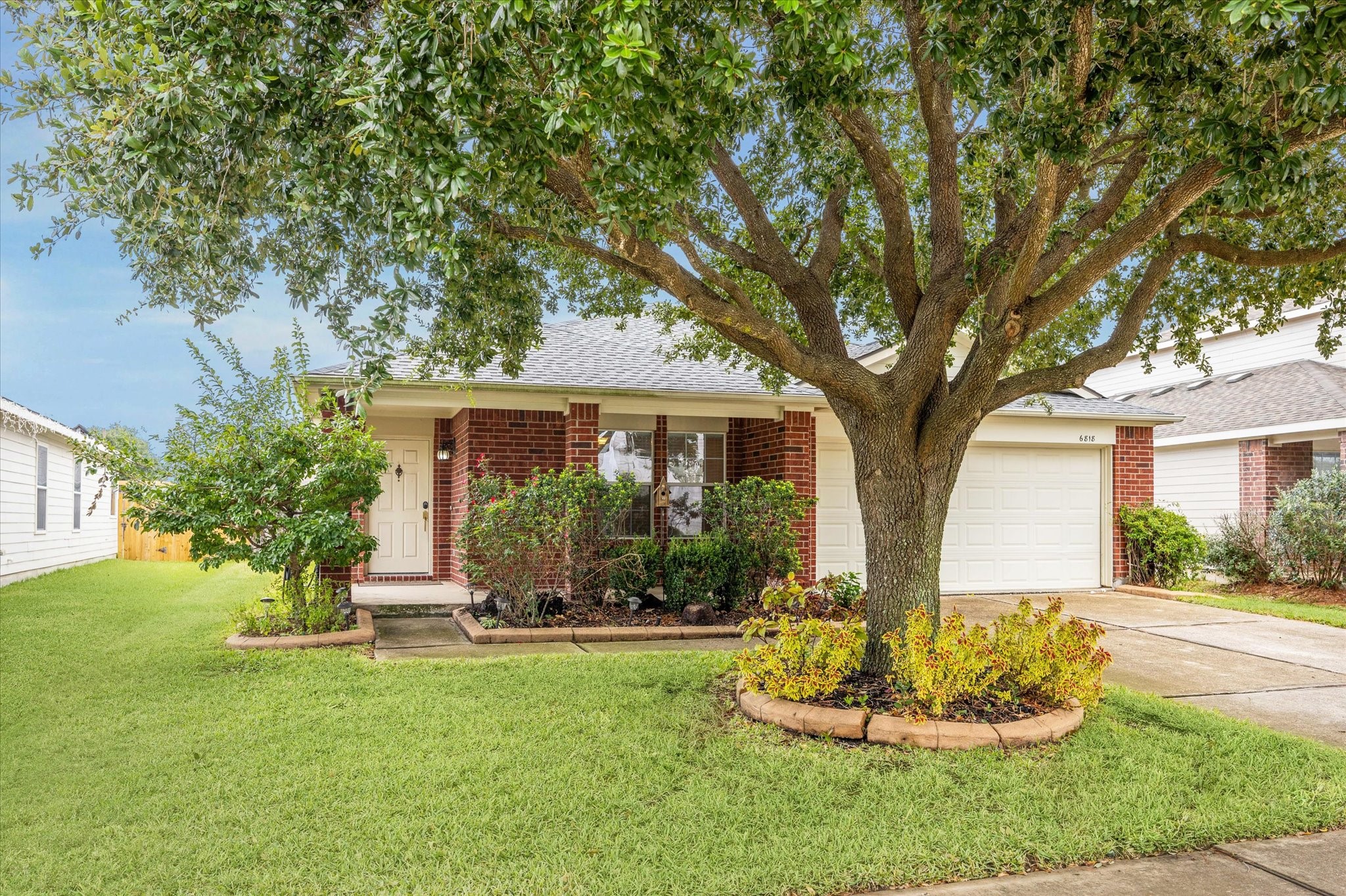 a front view of a house with a yard and trees