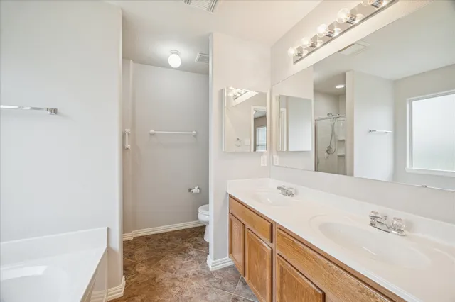 a spacious bathroom with a tub sink and mirror