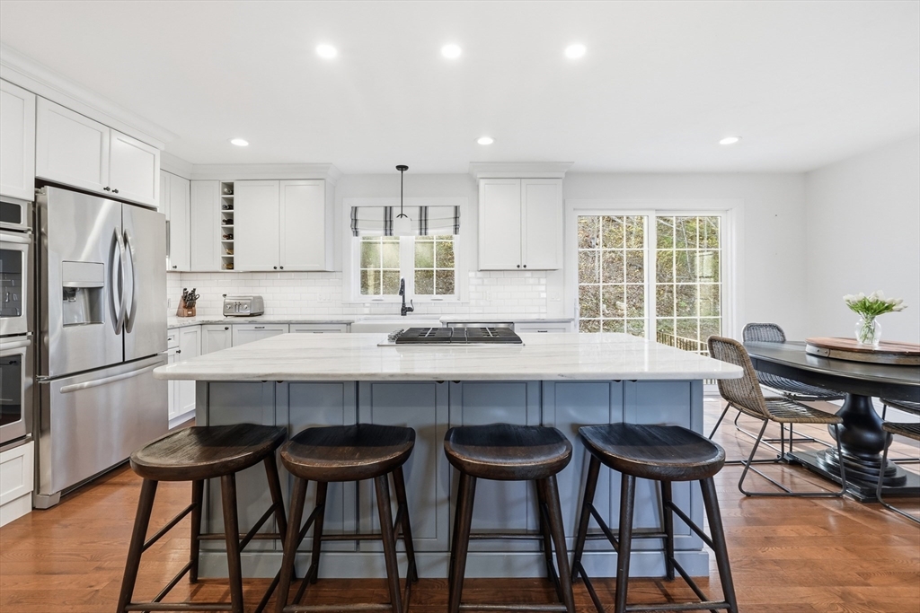 103 Rice Corner Road Brookfield, MA 01506 - Photo 4 of 39 a kitchen with a table chairs refrigerator and cabinets