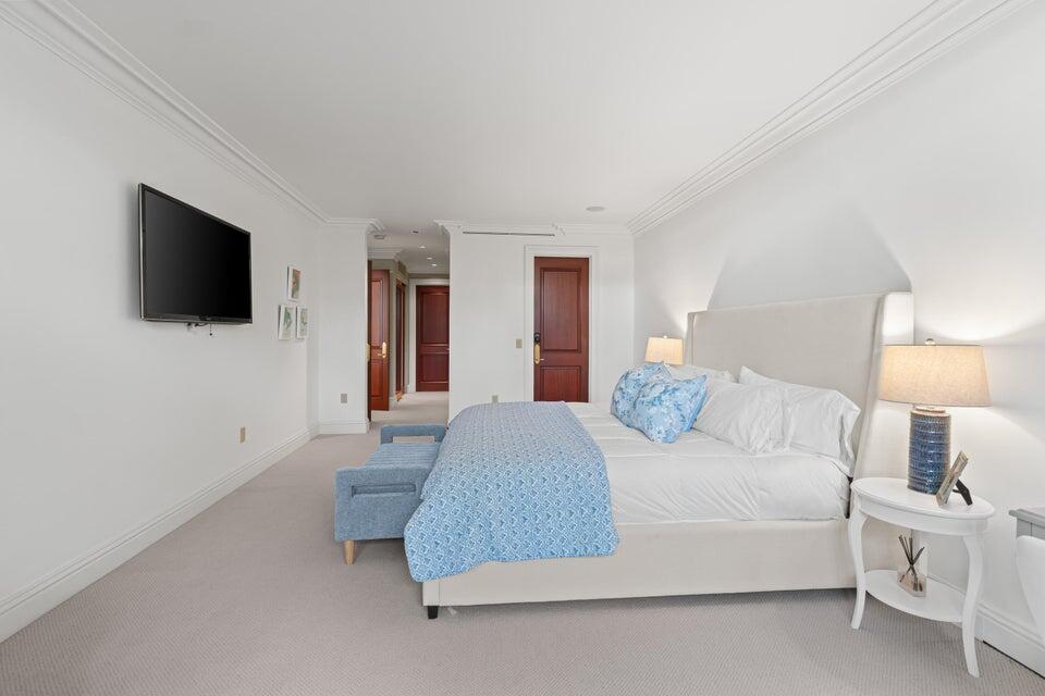 100 Royal Palm Way, Unit D1 Palm Beach, FL 33480 - Photo 12 of 22 a bedroom with a bed and a flat screen tv