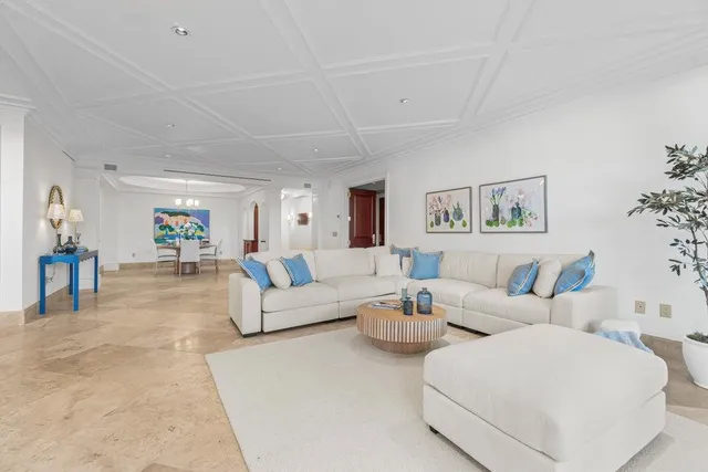 a living room with furniture and a view of bedroom