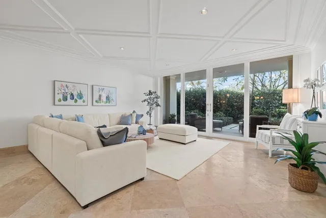 a living room with furniture and a large window with outer view