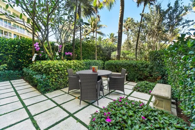 a view of a patio with table and chairs and potted plants