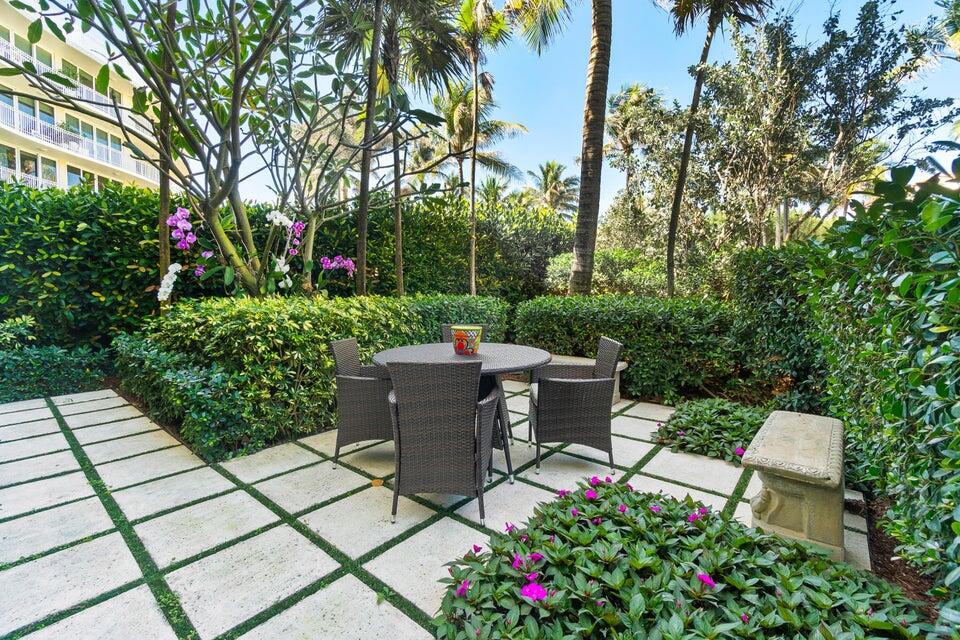100 Royal Palm Way, Unit D1 Palm Beach, FL 33480 - Photo 8 of 22 a view of a patio with table and chairs and potted plants