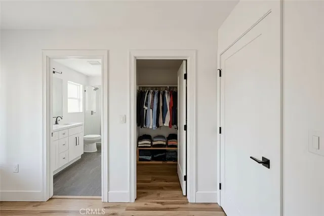 a hallway with white doors and wooden floor