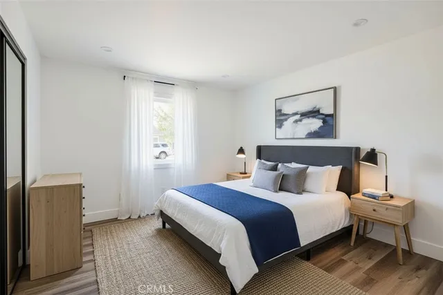 a bedroom with a bed and a night stand