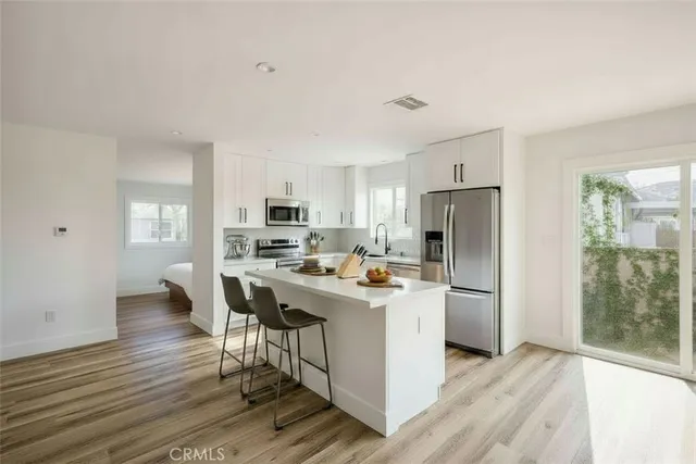 a kitchen with stainless steel appliances a stove a refrigerator and a refrigerator